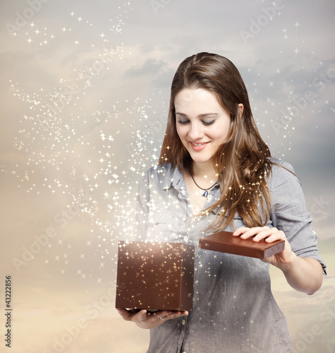 Photo: Woman Opening a Gift Box Woman Opening a Gift Box