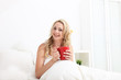 Friendly woman with beautiful smile in bed