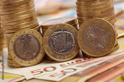 Photo: Euro coins on banknote money background Euro coins on banknote money background
