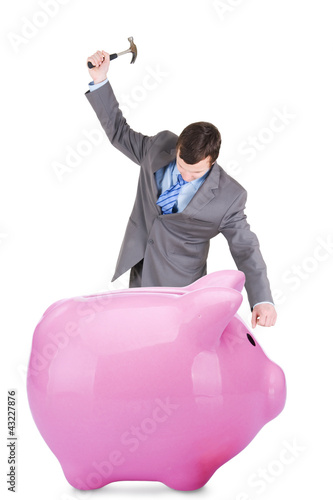 Photo: Young businessman and piggy bank Young businessman and piggy bank