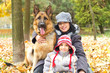 mother and son with dog in park