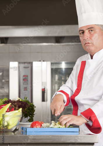Photo: chef at work in a restaurant chef at work in a restaurant