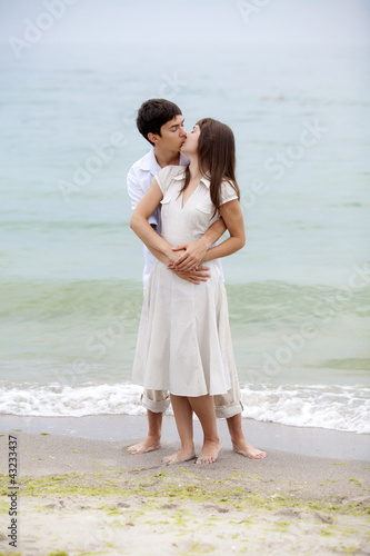 Photo: Couple kissing at the beach Couple kissing at the beach