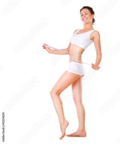 Photo: Woman measuring her waistline. Perfect Slim Body Woman measuring her waistline. Perfect Slim Body