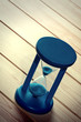 Hourglass on wooden surface.