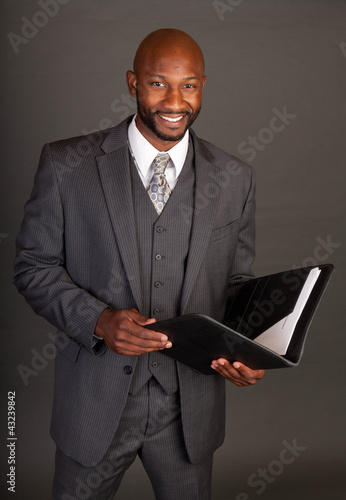 Photo: Young Black Business Man with a portfolio Young Black Business Man with a portfolio