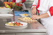 Foto: Two chefs at work in a restaurant Two chefs at work in a restaurant