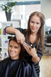 Photo: Stylist Giving a Haircut To Woman Stylist Giving a Haircut To Woman