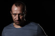 Angry man on black looking aggressive