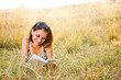 Photo: Woman lies on grass and reads book Woman lies on grass and reads book