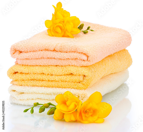 Photo: colorful towels and flowers isolated on white colorful towels and flowers isolated on white