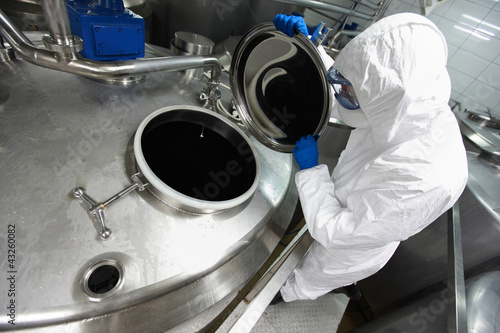 Photo: Specialist in protective uniform controlling industrial process Specialist in protective uniform controlling industrial process