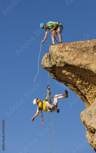 Photo: Climbing team struggles to the summit. Climbing team struggles to the summit.