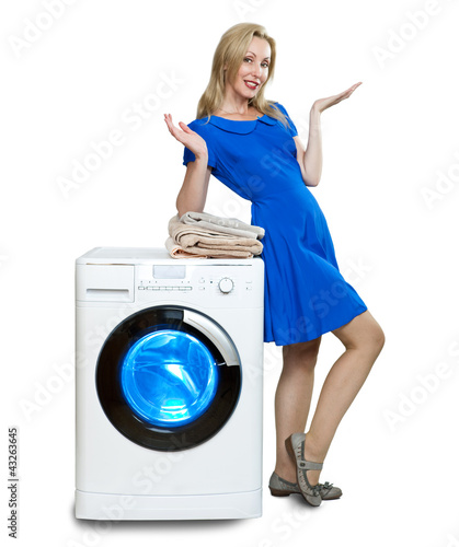 Photo: The happy young woman near the new washing machine The happy young woman near the new washing machine