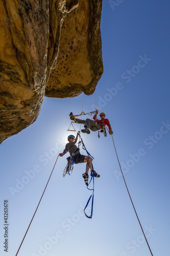 Photo: Climbing team struggles to the summit. Climbing team struggles to the summit.