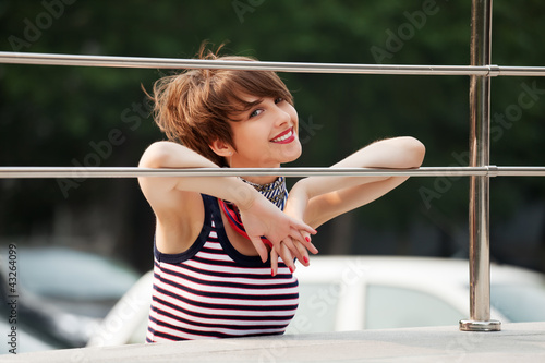 Foto: Happy young woman against a car parking Happy young woman against a car parking