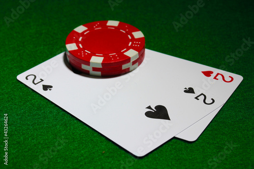 Photo: Cards and chips for poker on green table Cards and chips for poker on green table