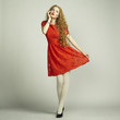 Fashion photo of young magnificent woman in red dress