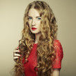 Portrait of beautiful woman with red hair in red dress