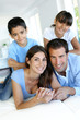 Portrait of happy family laying down bed