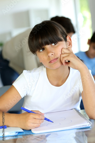 Photo: Young school girl with bored look on her face Young school girl with bored look on her face
