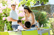 Mother serving lunch to kids in home garden