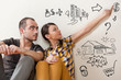 Closeup portrait of adult couple sitting on floor at their apart