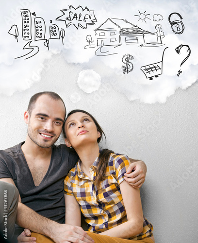 Photo: Closeup portrait of adult couple sitting on floor at their apart Closeup portrait of adult couple sitting on floor at their apart