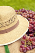 Straw hat and red grapes