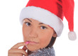 Close up of female in Santa Claus hat over a white background.