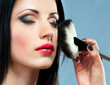 Photo: young woman with make-up brush young woman with make-up brush