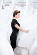 Shop assistant selects a dress for the bride