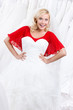 Bride admires her wedding dress, white background