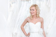 Youg girl is trying a beautiful wedding gown on