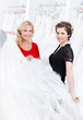 Bride is ready to try this wedding gown on, white background