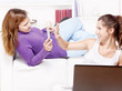 Foto: Two happy teenage girls having fun using electronic gadgets Two happy teenage girls having fun using electronic gadgets