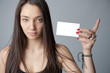 Attractive brunette holding a blank card