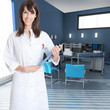 Photo: Young woman wearing a lab coat in an office Young woman wearing a lab coat in an office