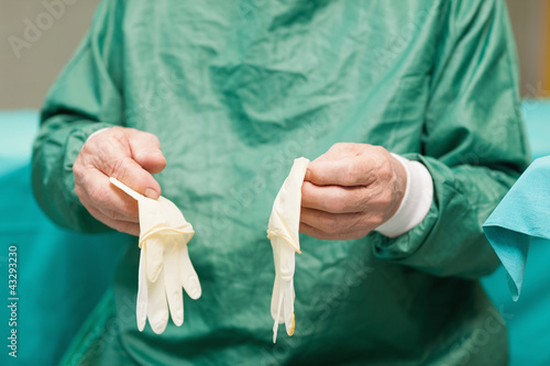 Photo: Surgeon holding surgical gloves Surgeon holding surgical gloves