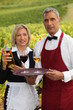 waiter and waitress serving wine