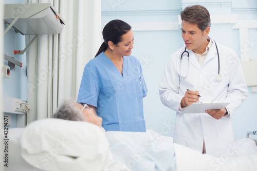 Photo: Doctor and nurse talking to a patient Doctor and nurse talking to a patient