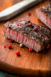 Grilled beef steak with peppercorns on wooden chopping board