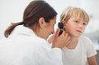 Photo: Doctor auscultating the ear of a child Doctor auscultating the ear of a child