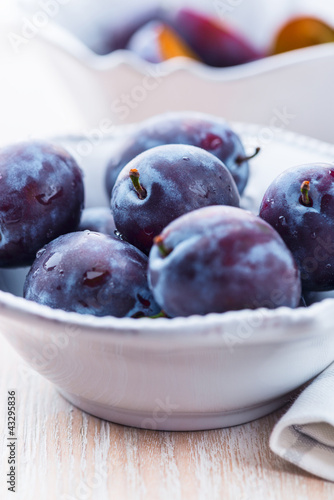 Photo: Close up of fresh plums in a bowl Close up of fresh plums in a bowl