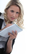 Blond office worker writing on note pad