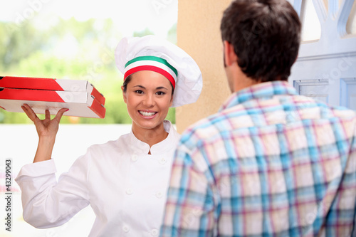 Photo: Woman delivering pizza Woman delivering pizza