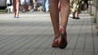 Naked female feet in the city and crowd