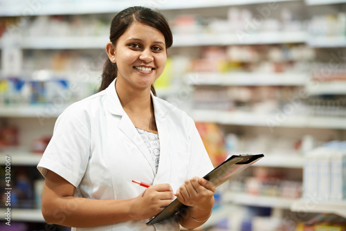 Photo: Pharmacy chemist woman in drugstore Pharmacy chemist woman in drugstore