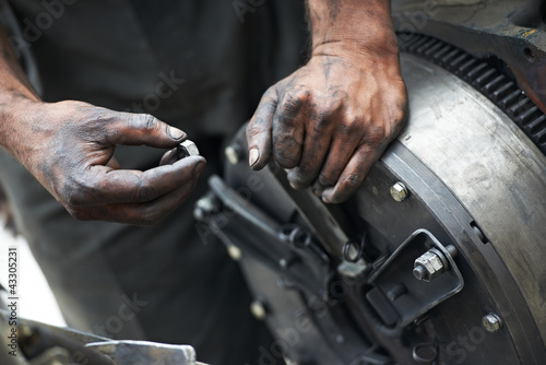 Photo: auto mechanic hands at car repair work auto mechanic hands at car repair work