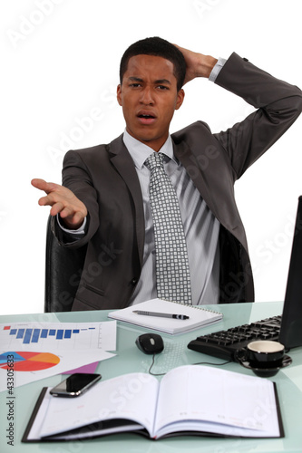 Photo: Troubled businessman remonstrating with the audience Troubled businessman remonstrating with the audience